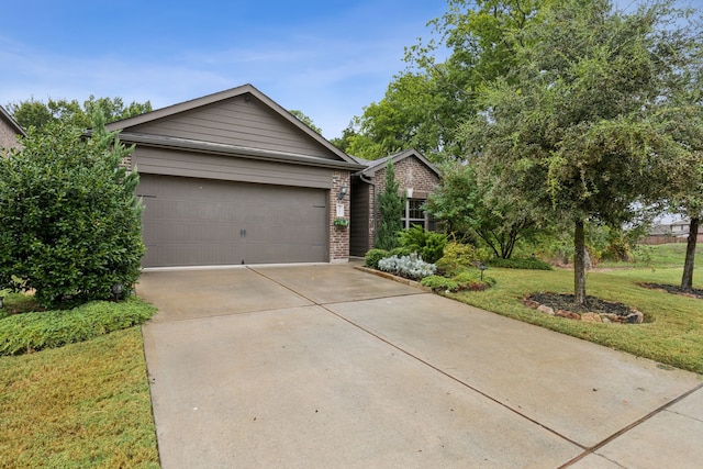 view of front of house with a garage and a front yard