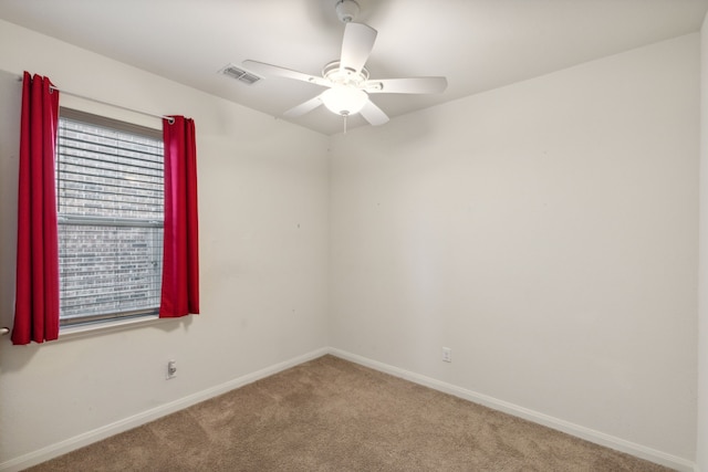 unfurnished room featuring ceiling fan and carpet flooring