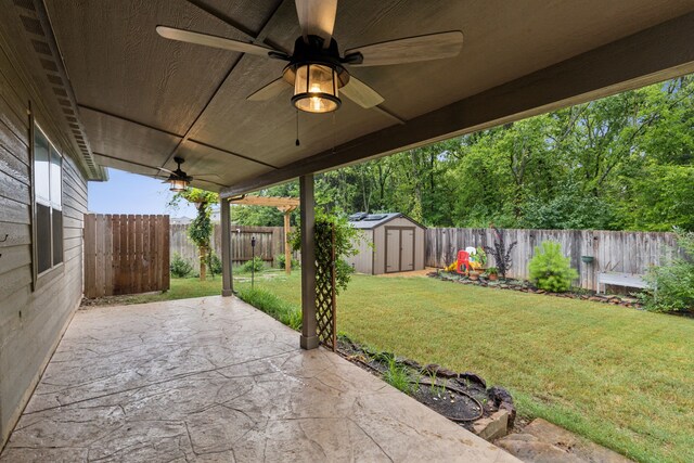 view of patio featuring ceiling fan and a storage unit