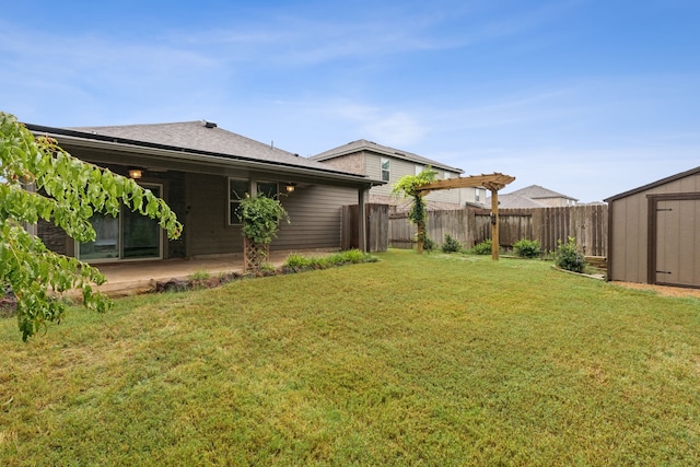 view of yard with a storage shed, a pergola, and a patio area