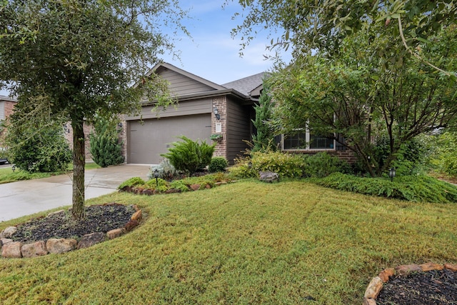 view of front of house featuring a garage and a front lawn