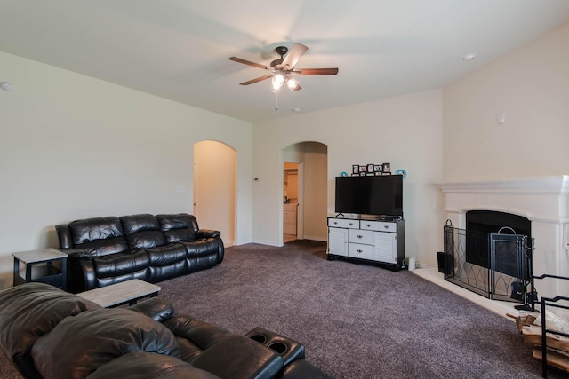 living room featuring ceiling fan and carpet