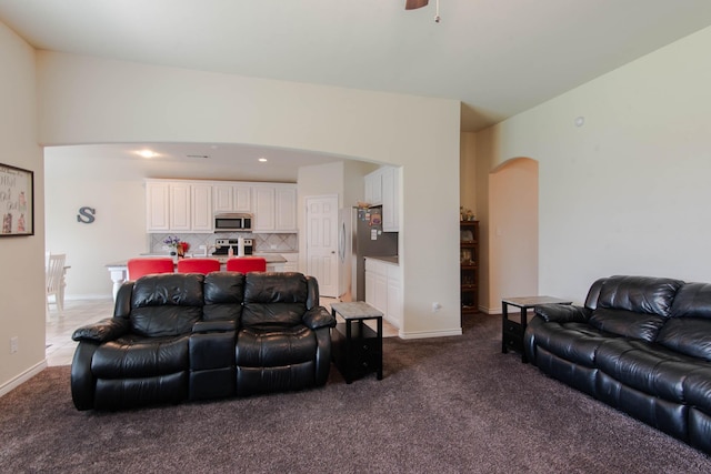 carpeted living room with ceiling fan