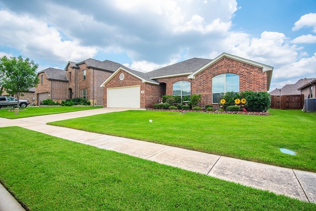 view of front of home with central air condition unit, a front lawn, and a garage