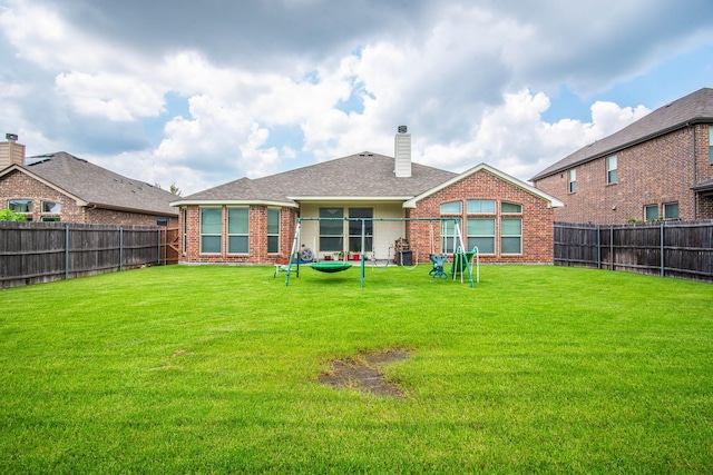 back of house with a lawn