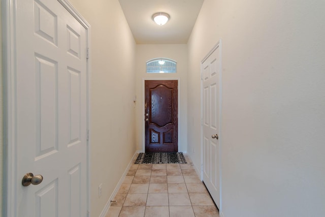 doorway to outside featuring light tile patterned flooring