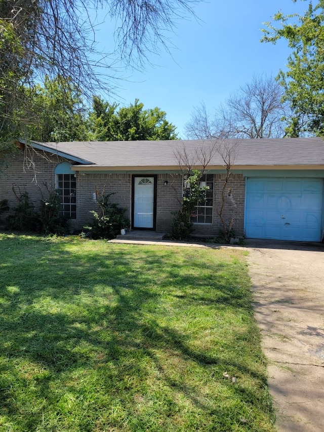 ranch-style home featuring a garage and a front lawn