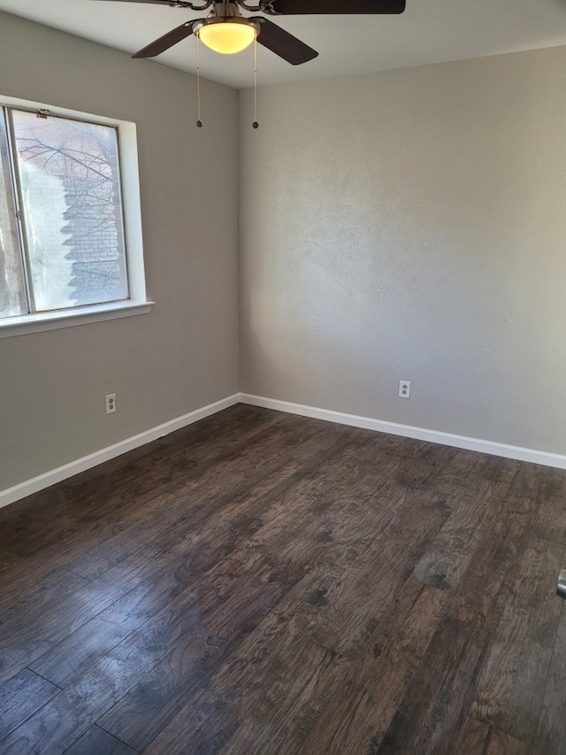 empty room with dark wood-type flooring and ceiling fan