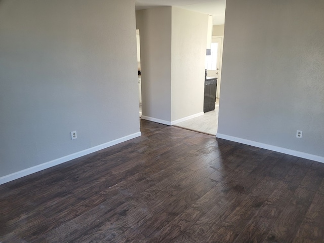 empty room with dark hardwood / wood-style floors