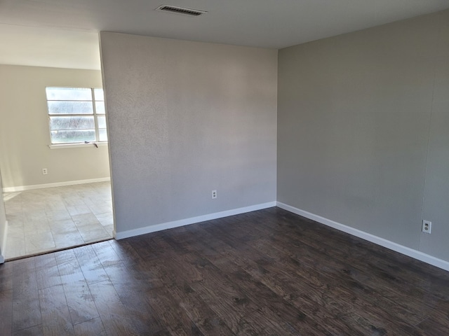 empty room featuring dark hardwood / wood-style flooring