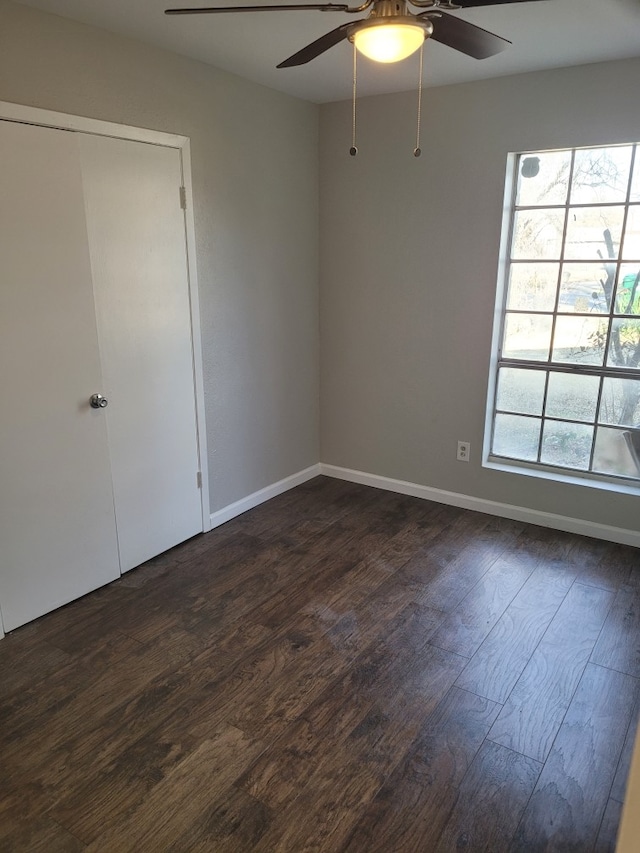 empty room featuring ceiling fan and dark hardwood / wood-style floors