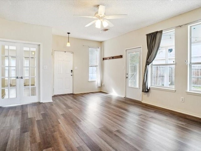 foyer featuring ceiling fan, dark wood-type flooring, a textured ceiling, and french doors