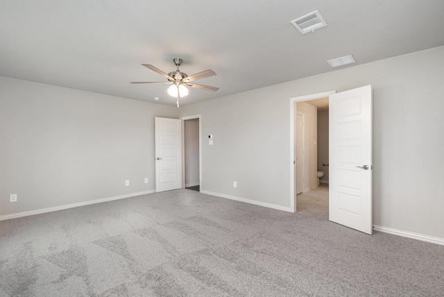 empty room with light colored carpet and ceiling fan