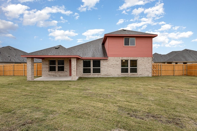 back of house with a patio area and a lawn