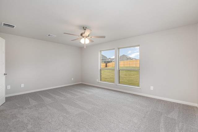 empty room featuring ceiling fan and carpet