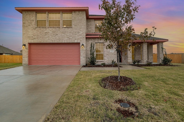 view of front of property featuring a garage and a lawn