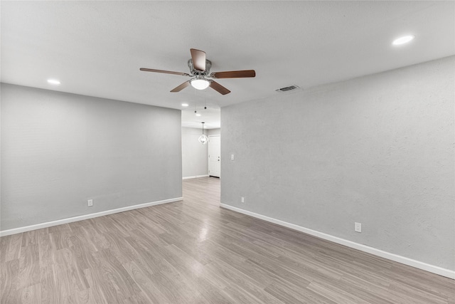 unfurnished room featuring light wood-type flooring and ceiling fan