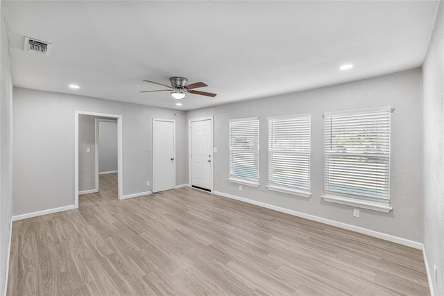 unfurnished room with ceiling fan and light wood-type flooring