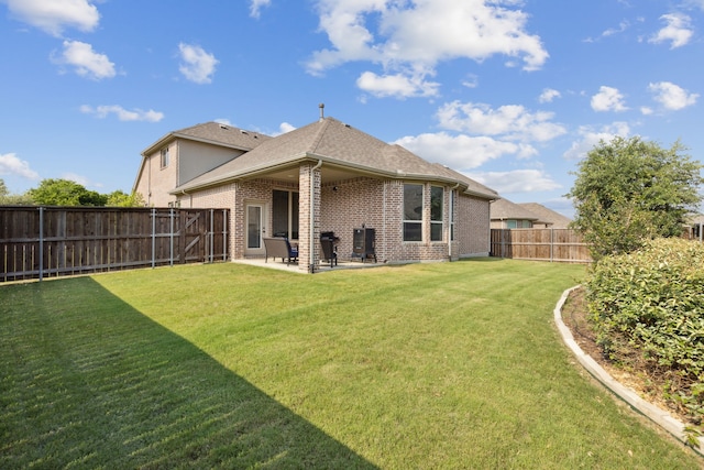 back of property with a lawn and a patio