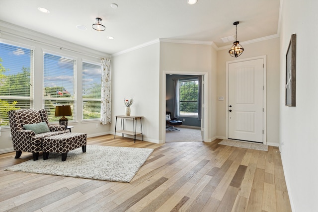 foyer featuring light hardwood / wood-style floors, a wealth of natural light, and a chandelier