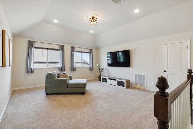 carpeted living room featuring lofted ceiling