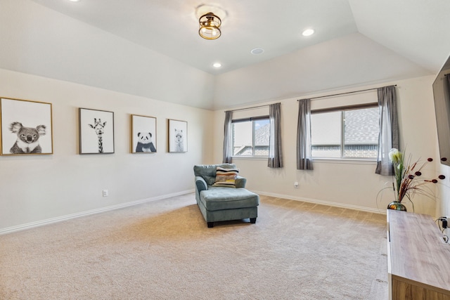 sitting room with light colored carpet, a tray ceiling, and lofted ceiling