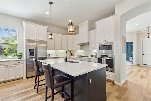 kitchen with sink, white cabinets, and appliances with stainless steel finishes