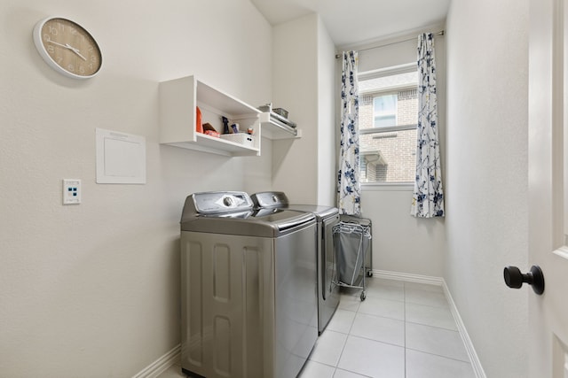 laundry area featuring separate washer and dryer and light tile patterned flooring