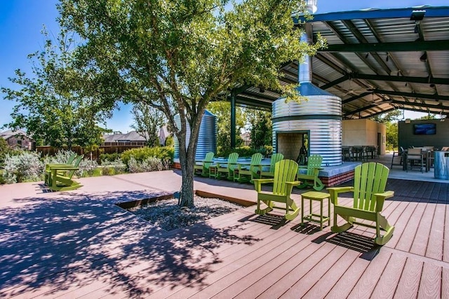 deck featuring an outdoor brick fireplace