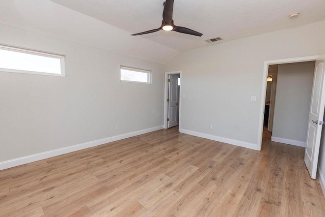 unfurnished room featuring visible vents, light wood-style floors, vaulted ceiling, ceiling fan, and baseboards