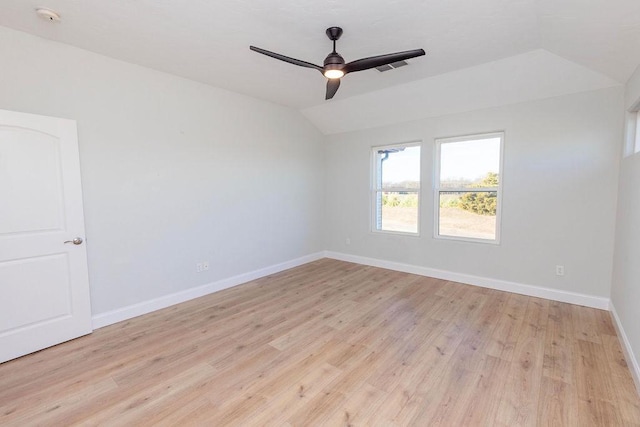 unfurnished room with a ceiling fan, baseboards, vaulted ceiling, visible vents, and light wood-style floors