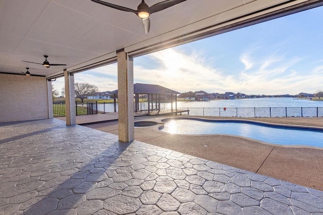 view of pool featuring fence, a patio, and an in ground hot tub