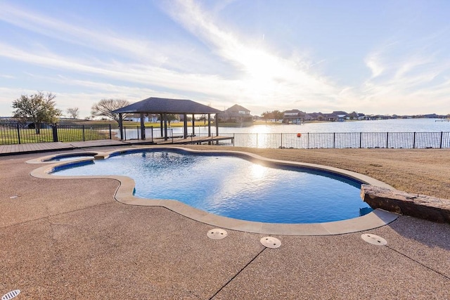 view of swimming pool with a water view, fence, a gazebo, a patio area, and a pool with connected hot tub