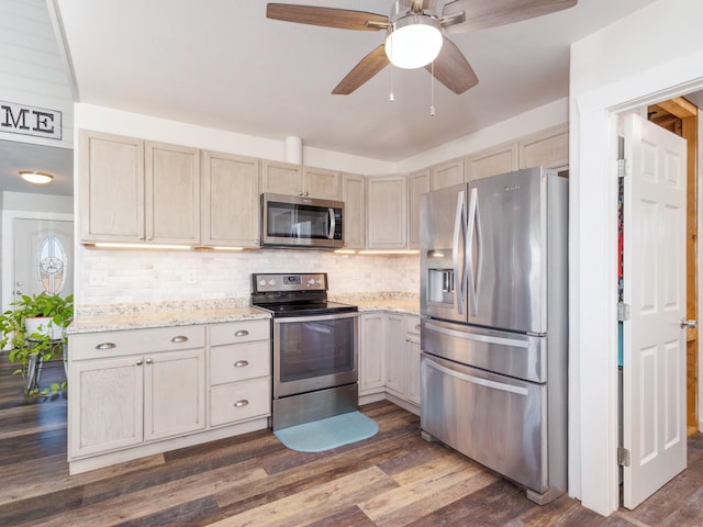 kitchen with tasteful backsplash, dark hardwood / wood-style floors, ceiling fan, and appliances with stainless steel finishes