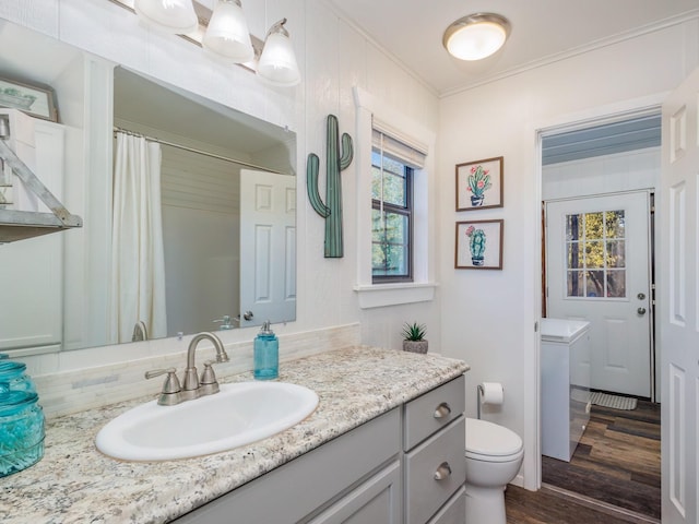 bathroom featuring vanity, wood-type flooring, ornamental molding, decorative backsplash, and toilet