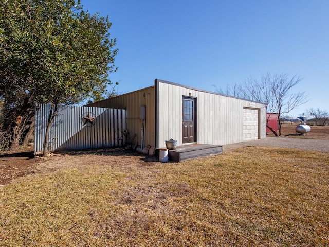 view of outbuilding featuring a yard and a garage