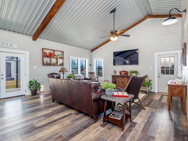 living room featuring wooden walls, ceiling fan, dark hardwood / wood-style floors, and beamed ceiling