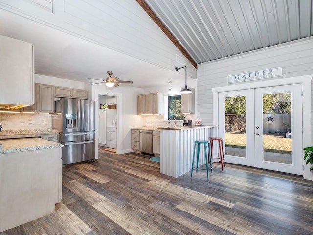 kitchen featuring hanging light fixtures, appliances with stainless steel finishes, light brown cabinetry, and french doors