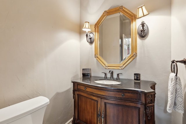 bathroom featuring toilet and vanity