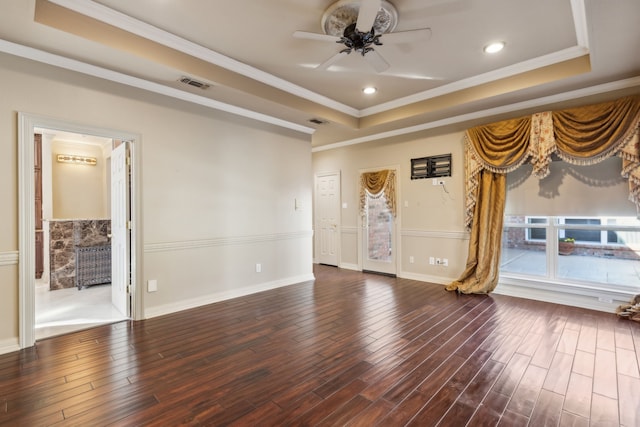 unfurnished living room featuring ceiling fan, wood-type flooring, crown molding, and a raised ceiling