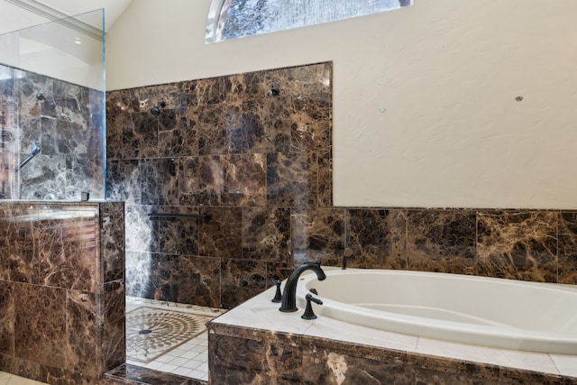 bathroom featuring lofted ceiling and separate shower and tub