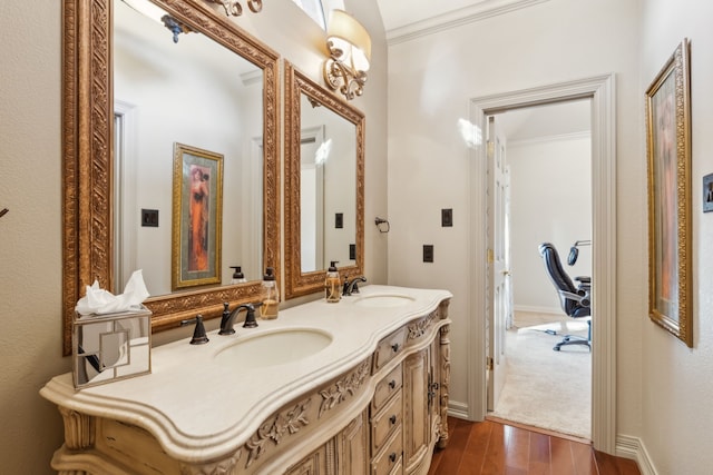 bathroom featuring vanity, crown molding, and hardwood / wood-style floors