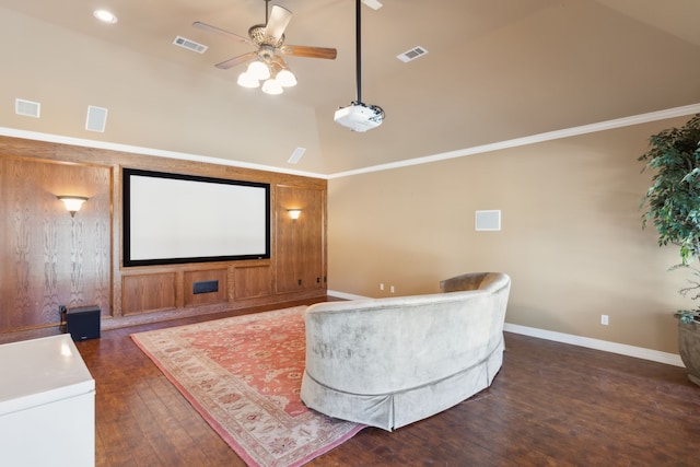 cinema with ceiling fan, dark wood-type flooring, crown molding, and high vaulted ceiling