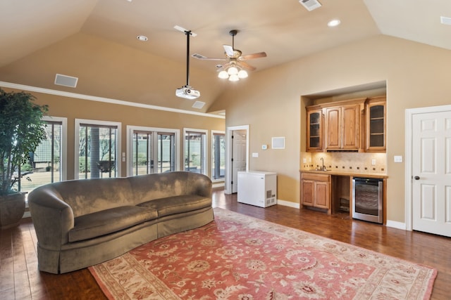 living room featuring dark wood-type flooring, ceiling fan, lofted ceiling, and wine cooler