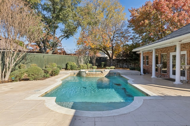 view of pool with a patio area and an in ground hot tub