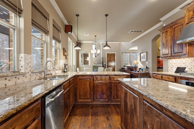 kitchen with dark hardwood / wood-style flooring, tasteful backsplash, stainless steel dishwasher, wall chimney exhaust hood, and sink