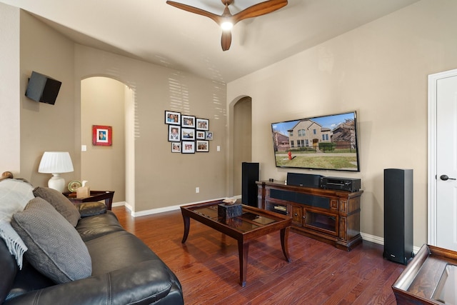 living room with ceiling fan and dark wood-type flooring