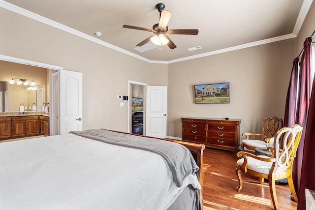 bedroom with wood-type flooring, connected bathroom, ceiling fan, and crown molding