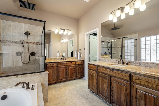 bathroom with tile patterned floors, vanity, plus walk in shower, and vaulted ceiling