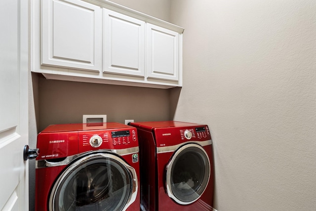 washroom with cabinets and separate washer and dryer